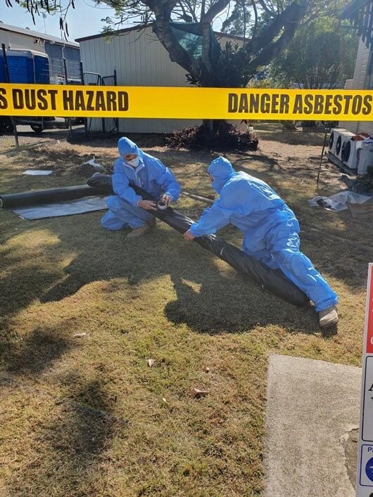 Asbestos removal exclusion zone marked out with hazard warning tape