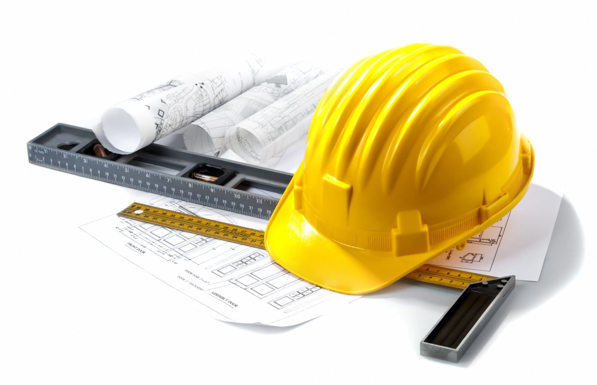Hand tools and building plans laid out on a workbench